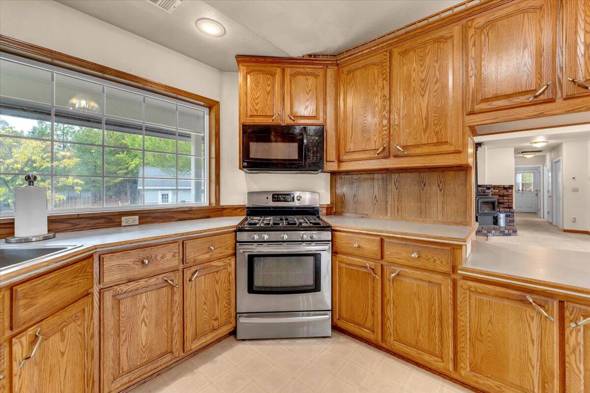 30153 Frisby Road Oak Run, CA 96069 - Photo 15 of 56 a kitchen with granite countertop cabinets stainless steel appliances and a window