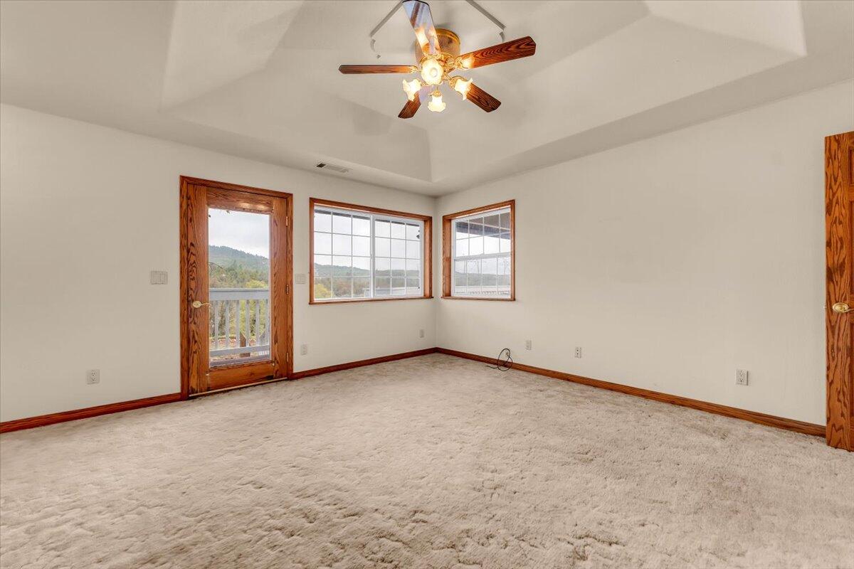 30153 Frisby Road Oak Run, CA 96069 - Photo 18 of 56 an empty room with chandelier fan and windows