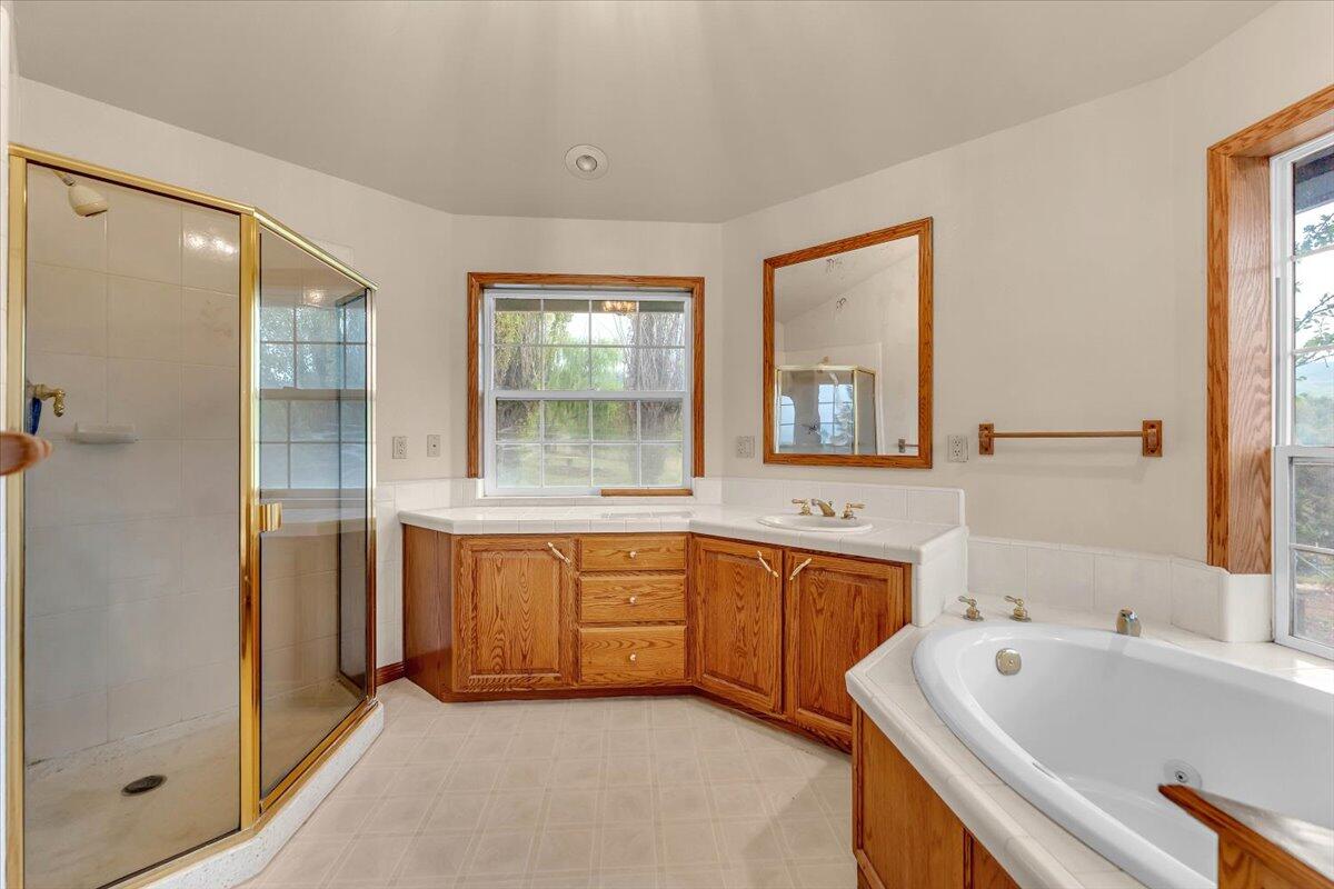 30153 Frisby Road Oak Run, CA 96069 - Photo 22 of 56 a spacious bathroom with a tub sink shower and mirror