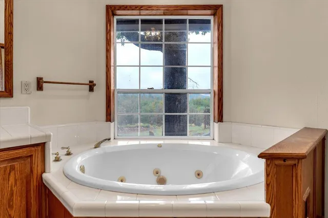 an empty room with windows and mirror