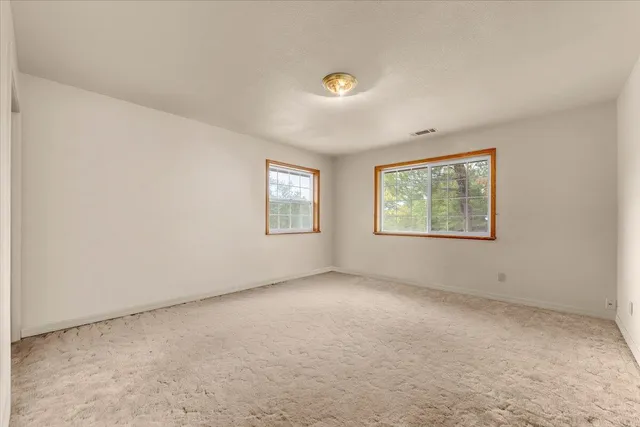 a bathroom with a double vanity sink a toilet a mirror and bathtub