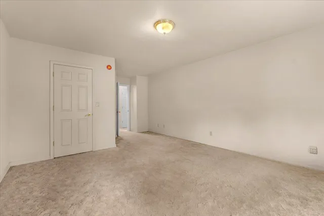 a view of an empty room with cabinet door
