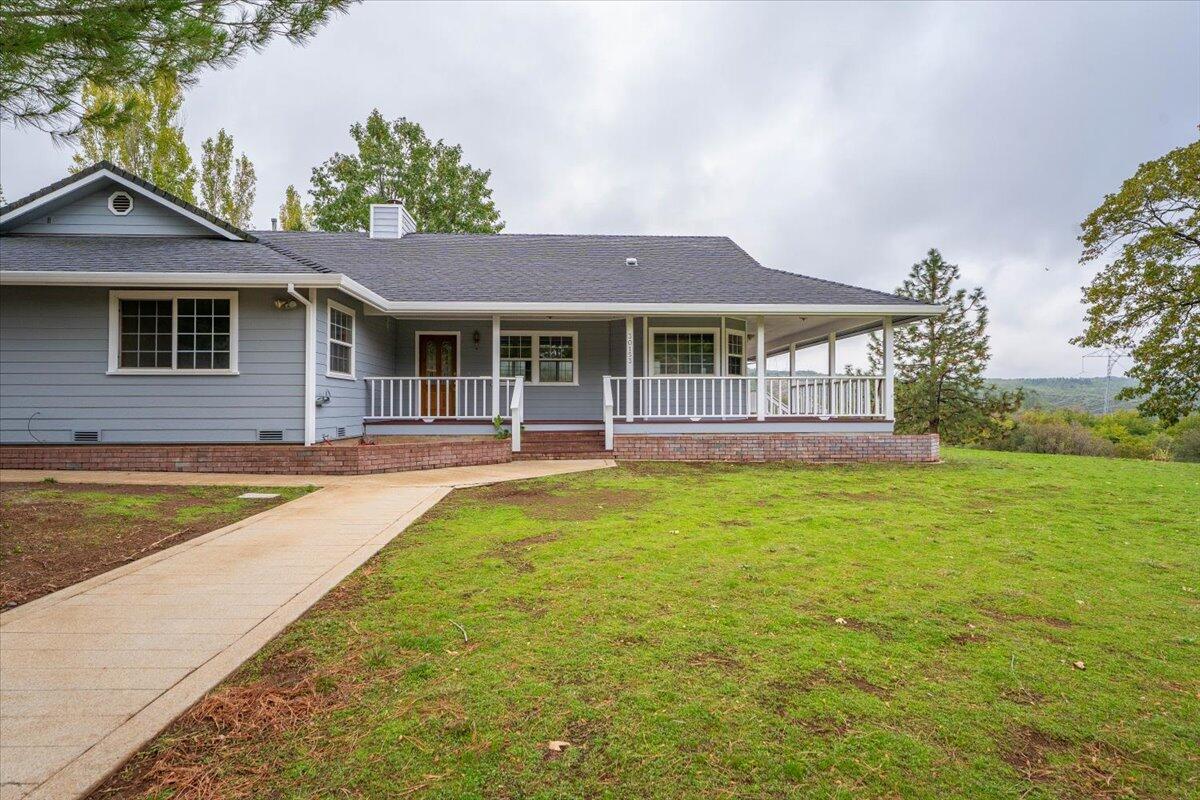 30153 Frisby Road Oak Run, CA 96069 - Photo 5 of 56 a front view of a house with a yard table and chairs