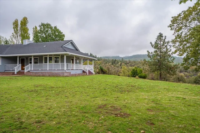 a view of a house with a yard and deck