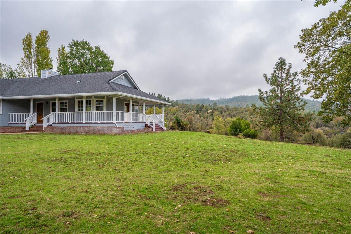 30153 Frisby Road Oak Run, CA 96069 - Photo 6 of 56 a view of a house with a garden and trees