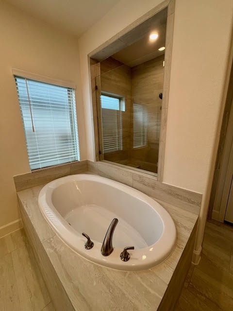 14910 Slough View Court Magnolia, TX 77354 - Photo 15 of 37 a bath tub sitting in a bathroom next to a window