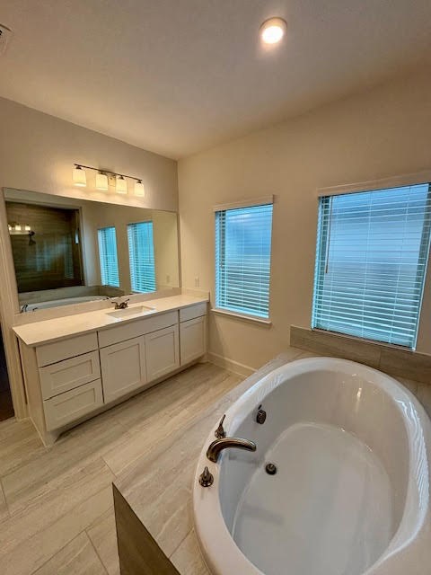 14910 Slough View Court Magnolia, TX 77354 - Photo 16 of 37 a bathroom with a tub sink and mirror