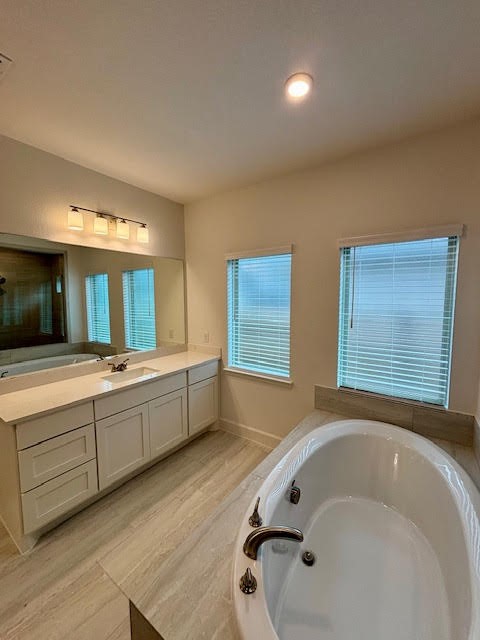 14910 Slough View Court Magnolia, TX 77354 - Photo 22 of 37 a bathroom with a bathtub and double vanity