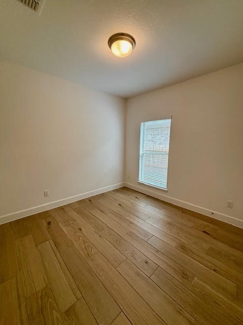 14910 Slough View Court Magnolia, TX 77354 - Photo 26 of 37 an empty room with wooden floor and windows