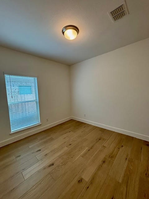 14910 Slough View Court Magnolia, TX 77354 - Photo 27 of 37 an empty room with wooden floor and windows