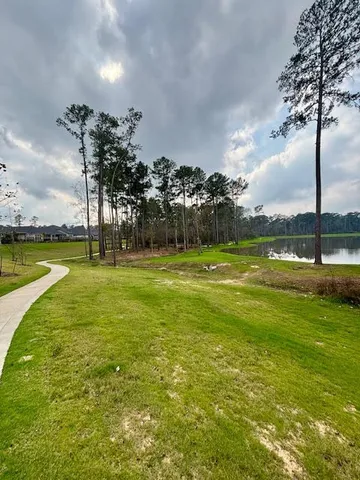 a view of a swimming pool and a yard