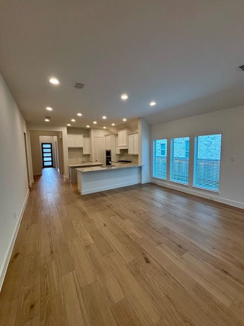 14910 Slough View Court Magnolia, TX 77354 - Photo 8 of 37 a view of an empty room with wooden floor and a window