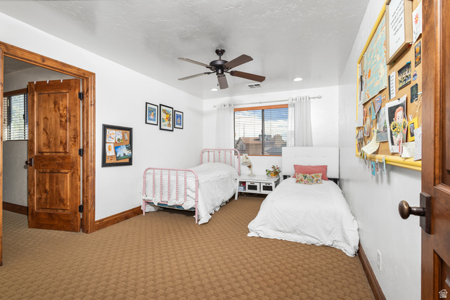 892 Cambridge Drive St. George, UT 84770 - Photo 39 of 65 Interior room featuring wood-finish panel doors, a ceiling fan with integrated lighting, recessed lighting, a window with horizontal blinds, and patterned carpeting