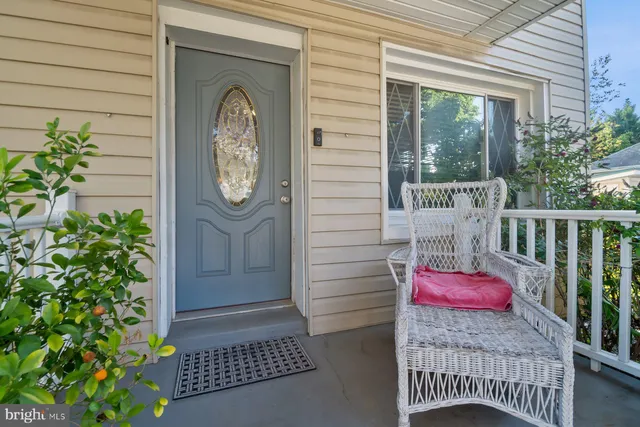 a view of a door and a bench in patio