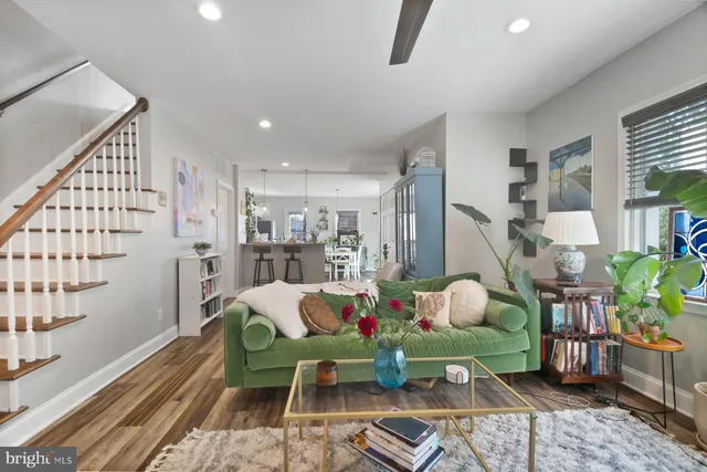 a living room with furniture and wooden floor