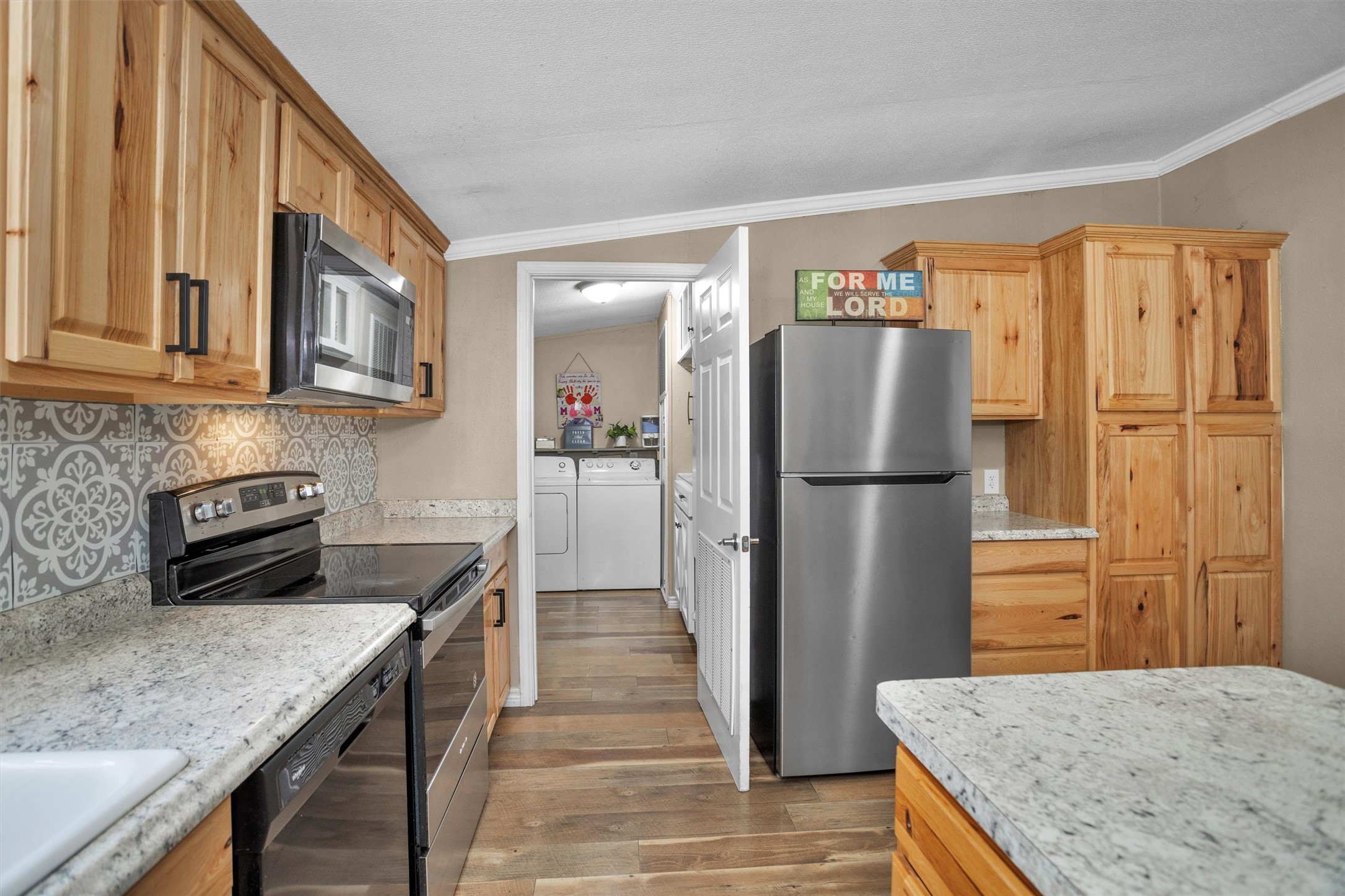 14604 Hasara Lane Willis, TX 77378 - Photo 20 of 50 a kitchen with stainless steel appliances granite countertop a refrigerator a stove and a sink