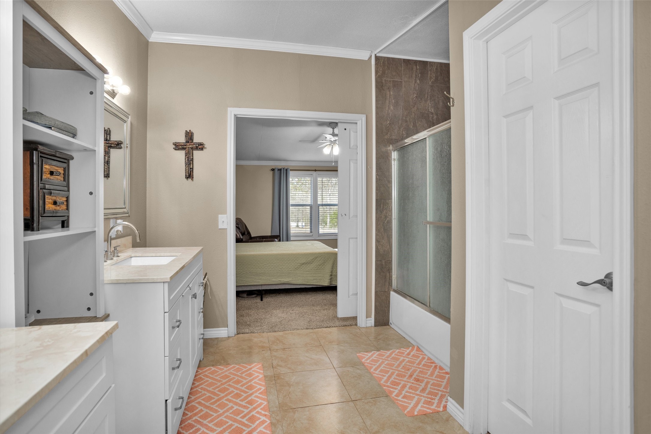 14604 Hasara Lane Willis, TX 77378 - Photo 29 of 50 a en suite bathroom with a sink a mirror and a shower