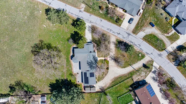 a front view of a house with a garden and trees