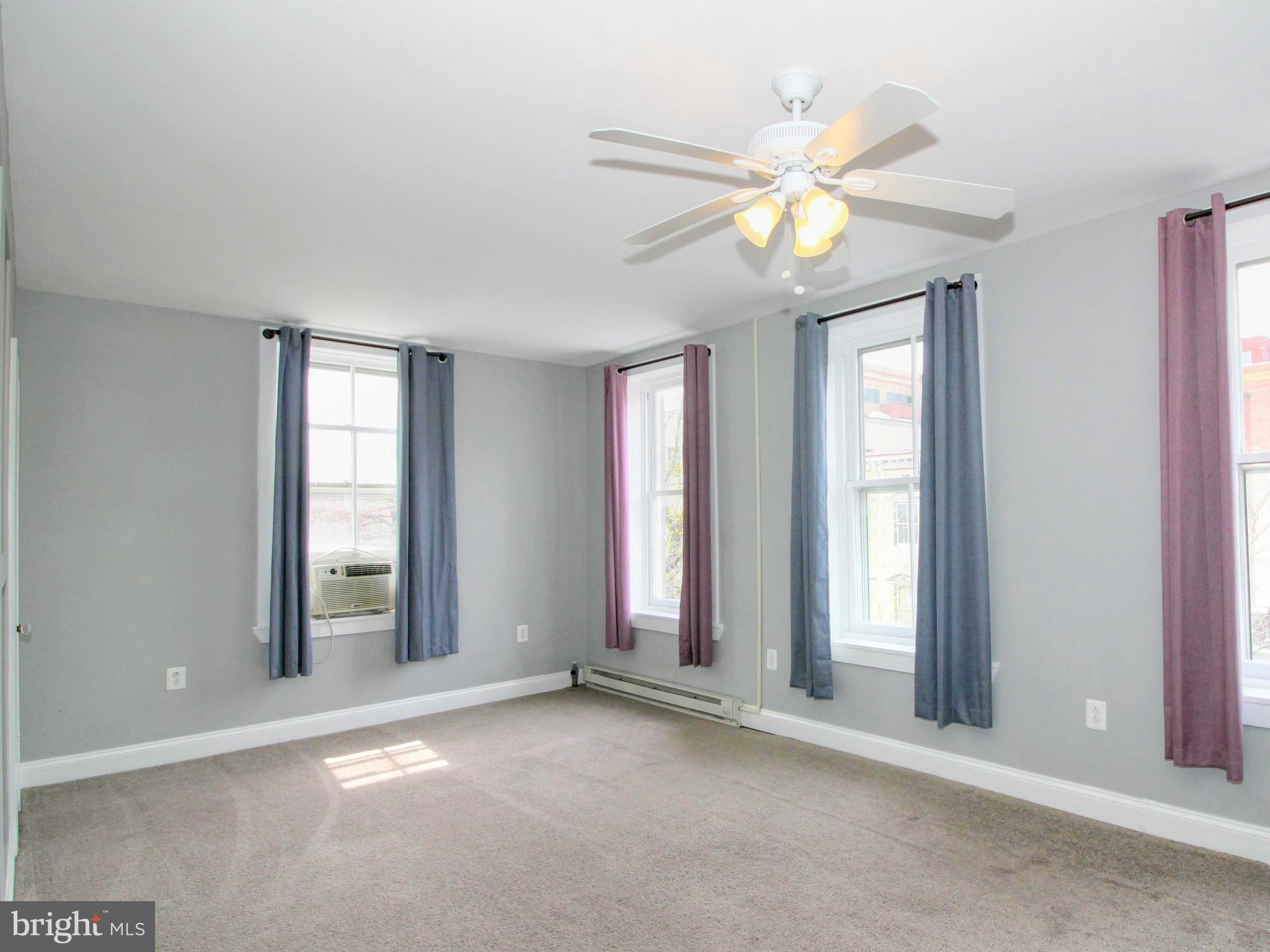 22 North Market Street, Unit 3 Frederick, MD 21701 - Photo 11 of 16 an empty room with windows and fan