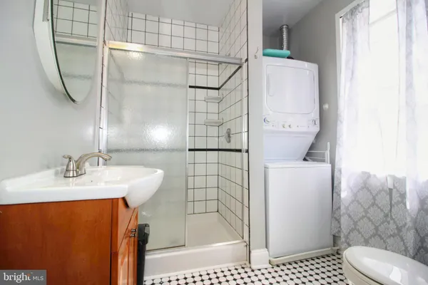 a kitchen with granite countertop a stove a oven a sink dishwasher and a microwave with wooden floor