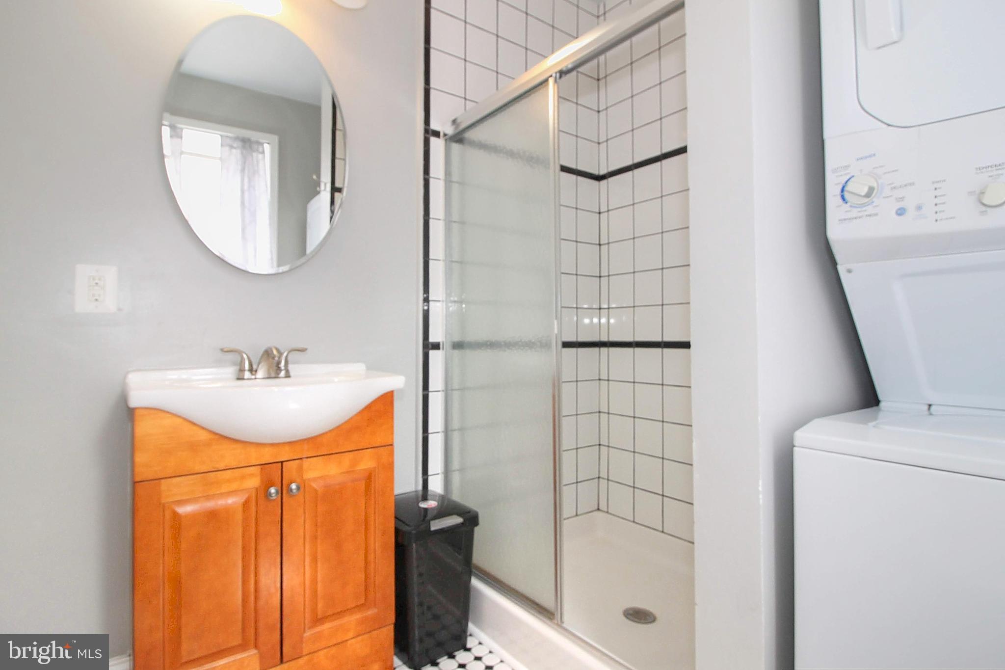 22 North Market Street, Unit 3 Frederick, MD 21701 - Photo 14 of 16 a bathroom with a sink a mirror and a shower