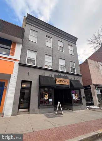 a view of a building with car parked