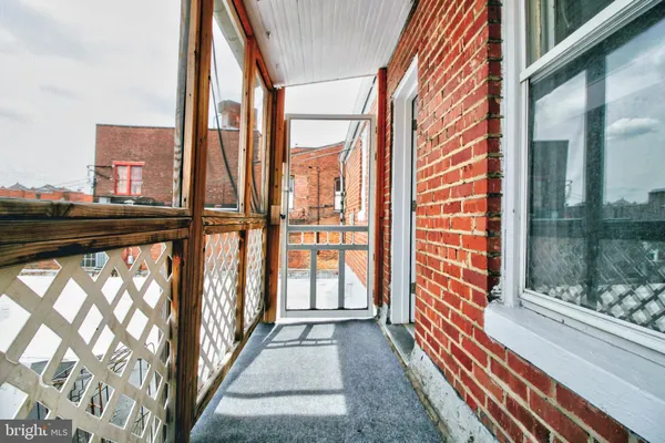 a view of kitchen with refrigerator and window