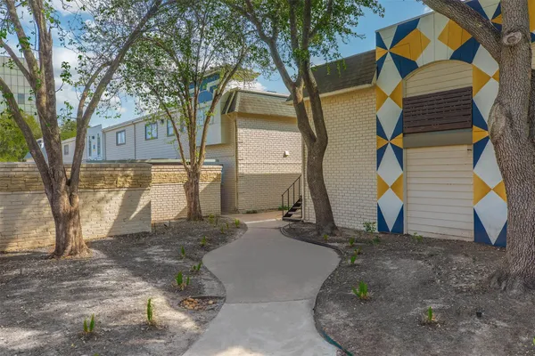 a view of a house with a yard and tree s
