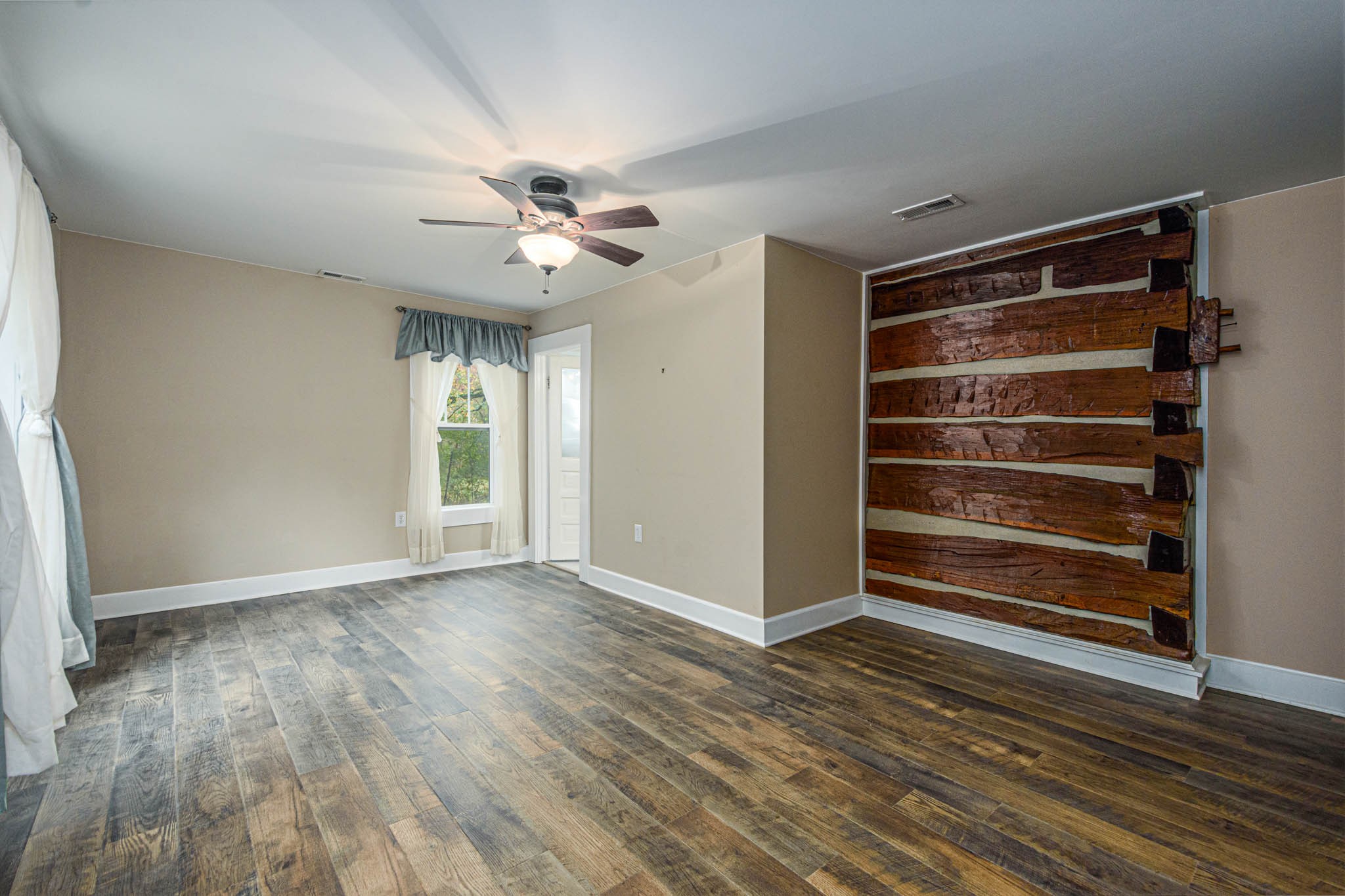 1828 Bunker Hill Road Pulaski, TN 38478 - Photo 21 of 57 a view of an empty room with a window and wooden floor
