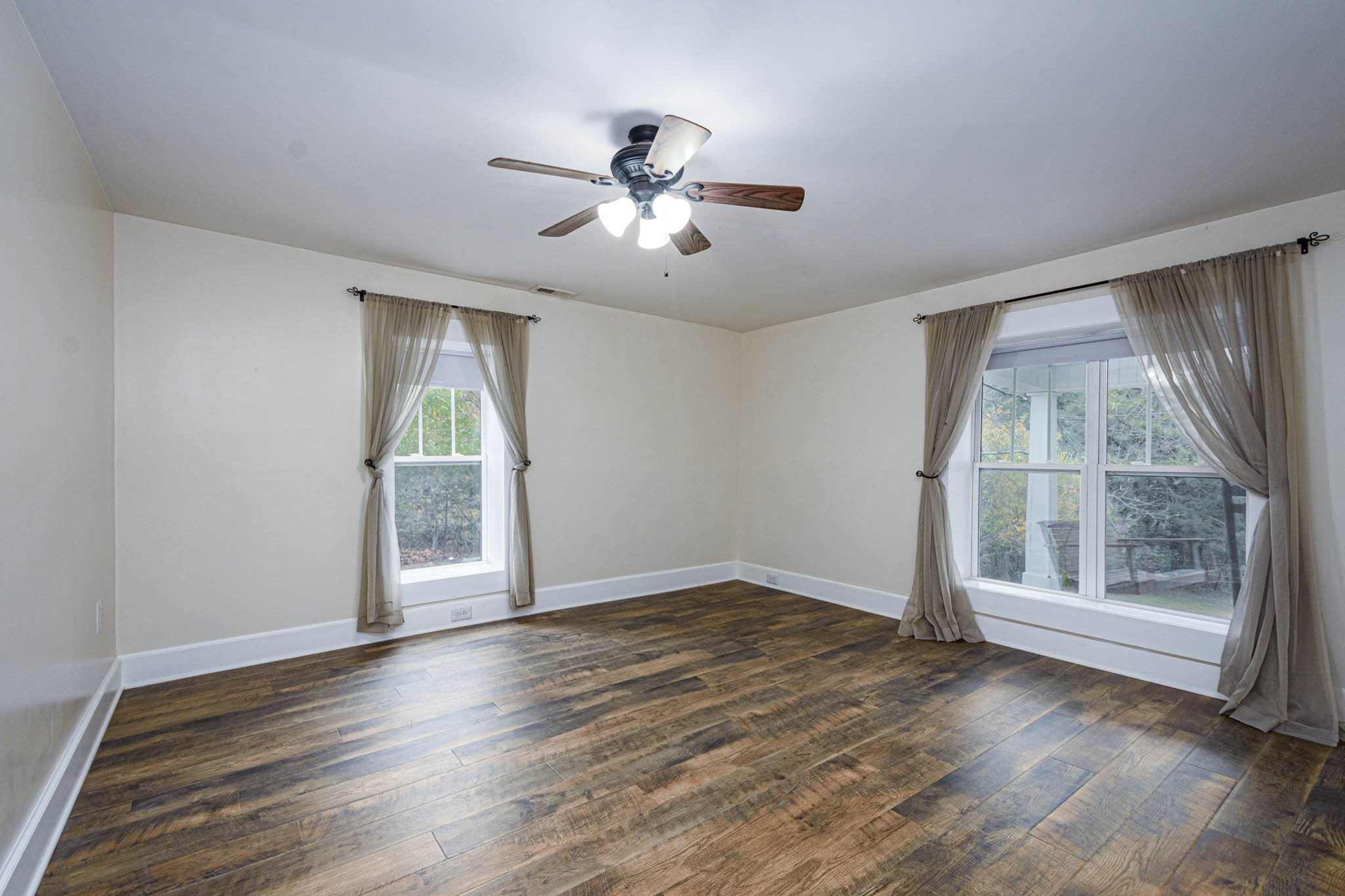 1828 Bunker Hill Road Pulaski, TN 38478 - Photo 30 of 57 an empty room with wooden floor fan and windows