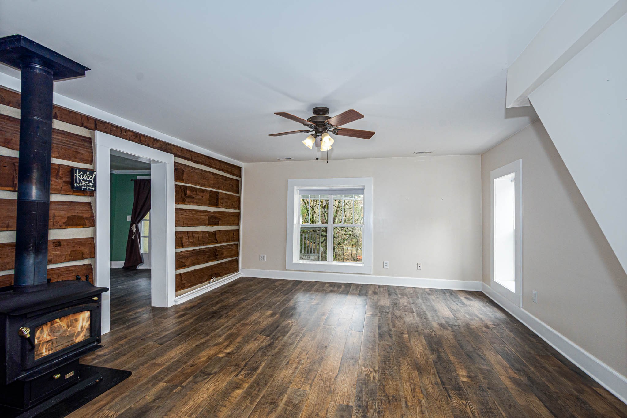 1828 Bunker Hill Road Pulaski, TN 38478 - Photo 8 of 57 a view of wooden floor and a ceiling fan in a living room