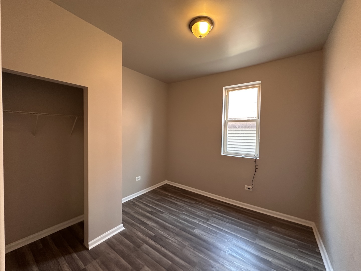4107 West 16th Street Chicago, IL 60623 - Photo 12 of 29 an empty room with wooden floor and windows