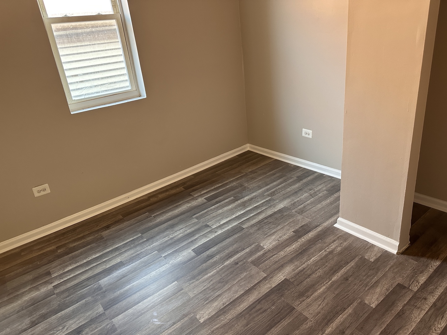 4107 West 16th Street Chicago, IL 60623 - Photo 15 of 29 a view of a room with wooden floor and window
