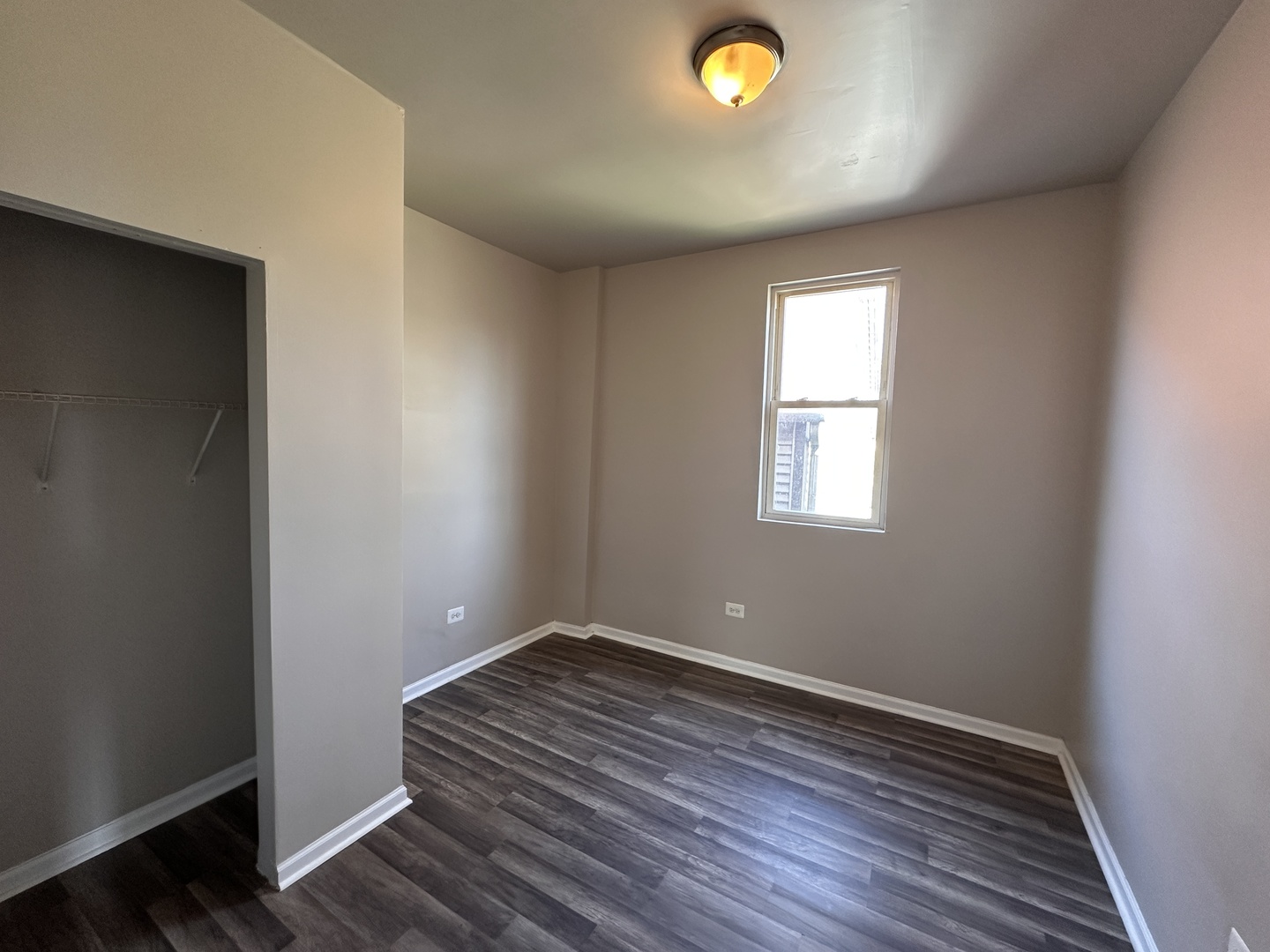 4107 West 16th Street Chicago, IL 60623 - Photo 21 of 29 an empty room with wooden floor and windows