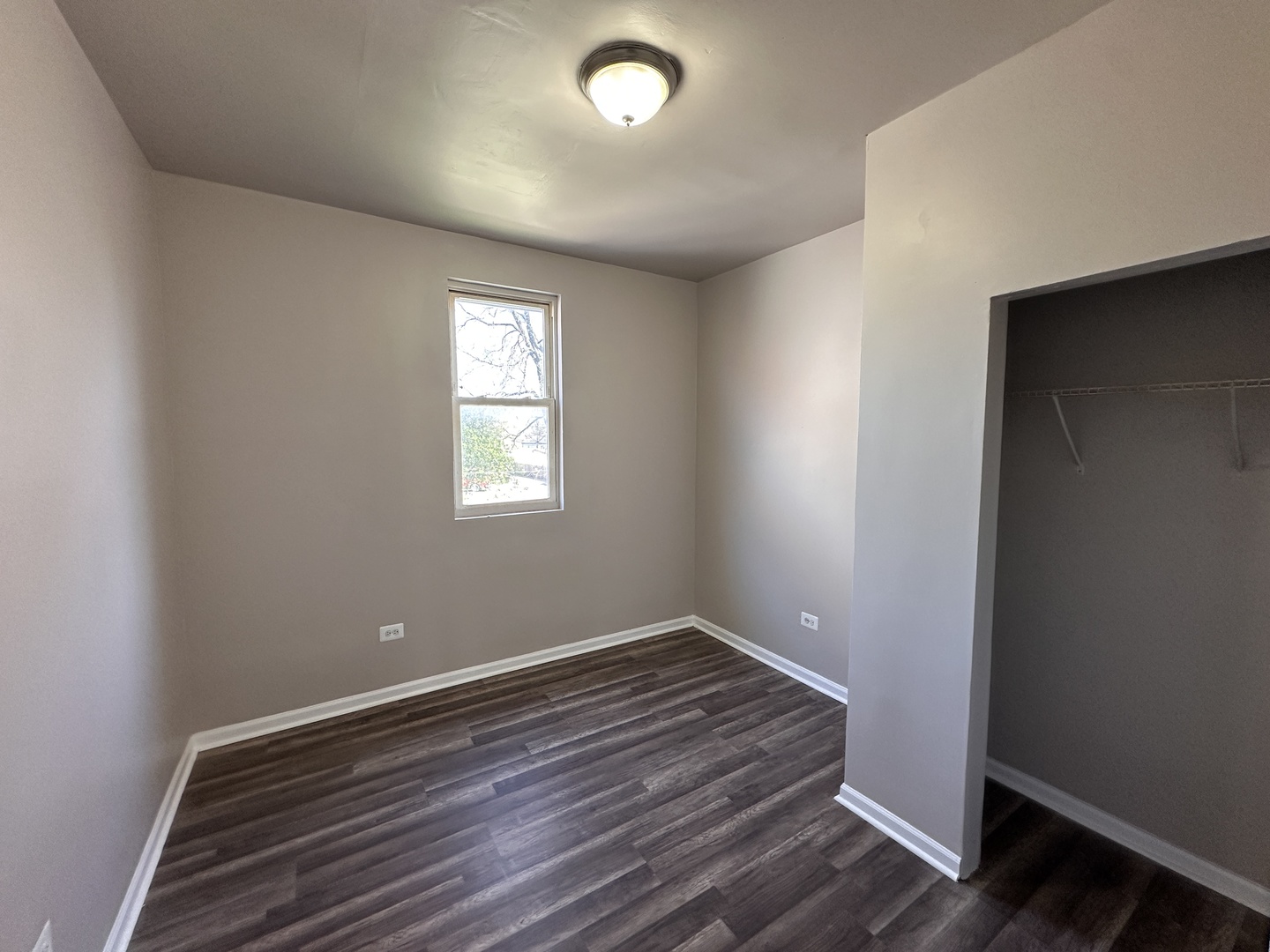 4107 West 16th Street Chicago, IL 60623 - Photo 23 of 29 an empty room with wooden floor and windows