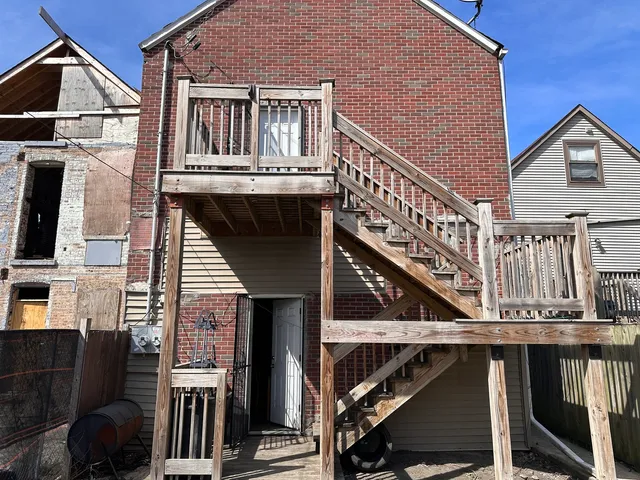 a view of balcony with wooden stairs and furniture