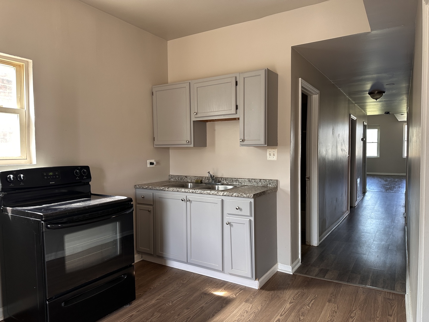 4107 West 16th Street Chicago, IL 60623 - Photo 4 of 29 a kitchen with stainless steel appliances granite countertop a stove and a refrigerator