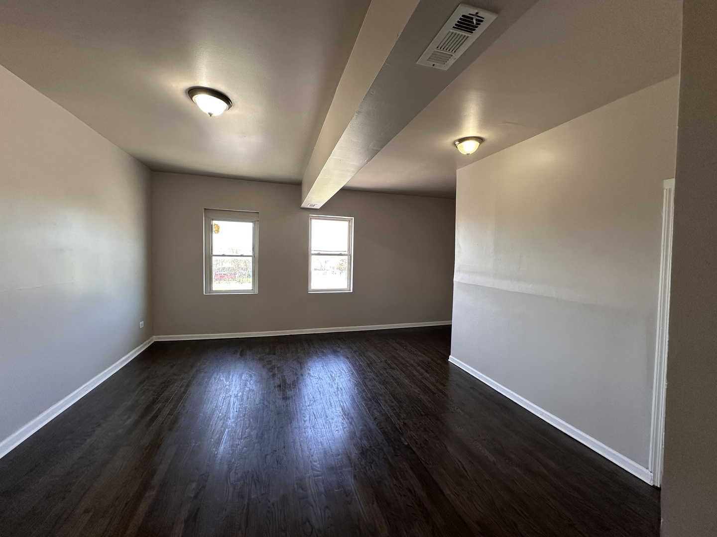 4107 West 16th Street Chicago, IL 60623 - Photo 6 of 29 an empty room with wooden floor and windows