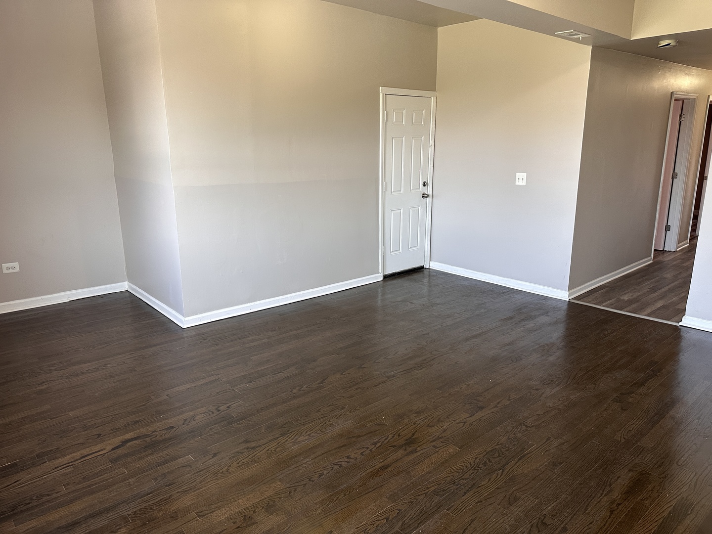 4107 West 16th Street Chicago, IL 60623 - Photo 8 of 29 an empty room with wooden floor and windows