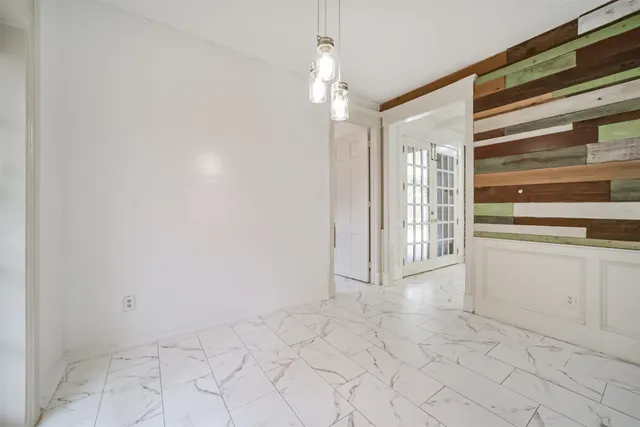 a view of a hallway with chandelier and entryway