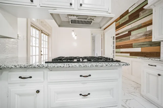 a kitchen with granite countertop a stove and a sink
