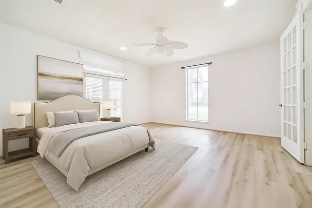 a bedroom with a bed and a window