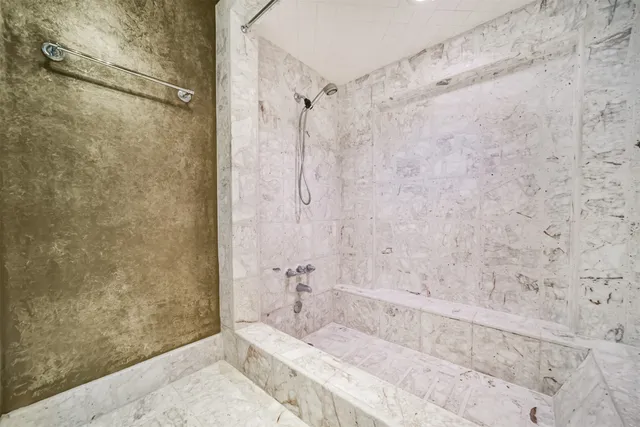 a bathroom with a bathtub and shower