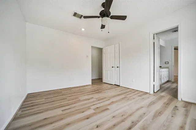 a view of an empty room and wooden floor