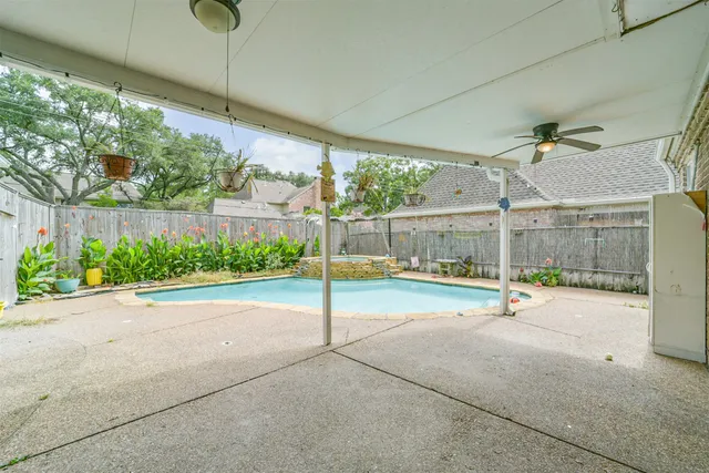 a view of a swimming pool with a patio