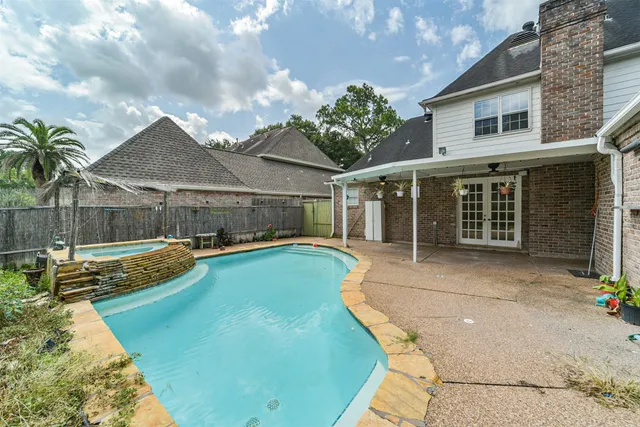 a view of a house with swimming pool and sitting area