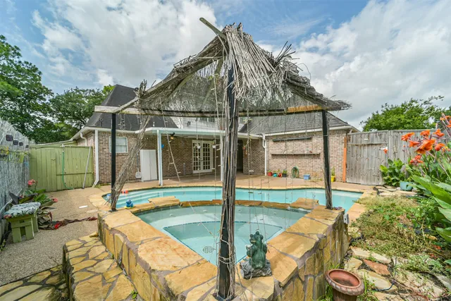 a view of a house with backyard outdoor seating and hardwood