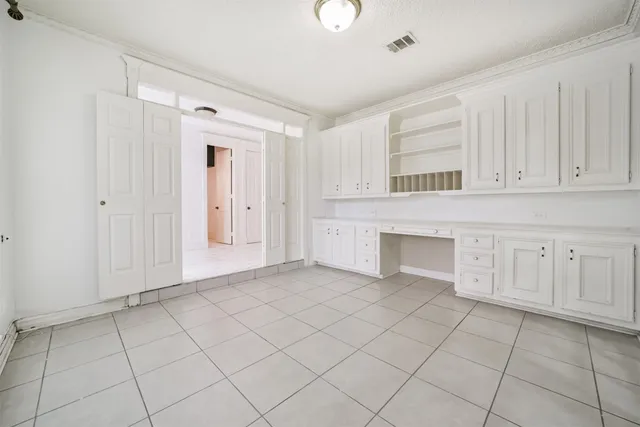 a view of kitchen with white cabinets