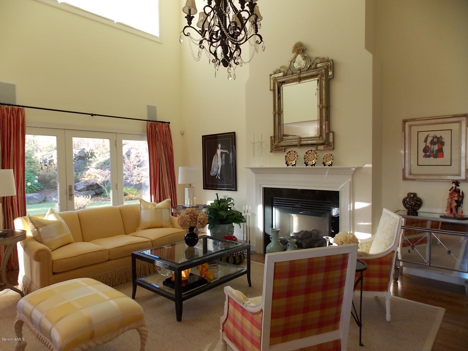 a living room with furniture a fireplace and a potted plant