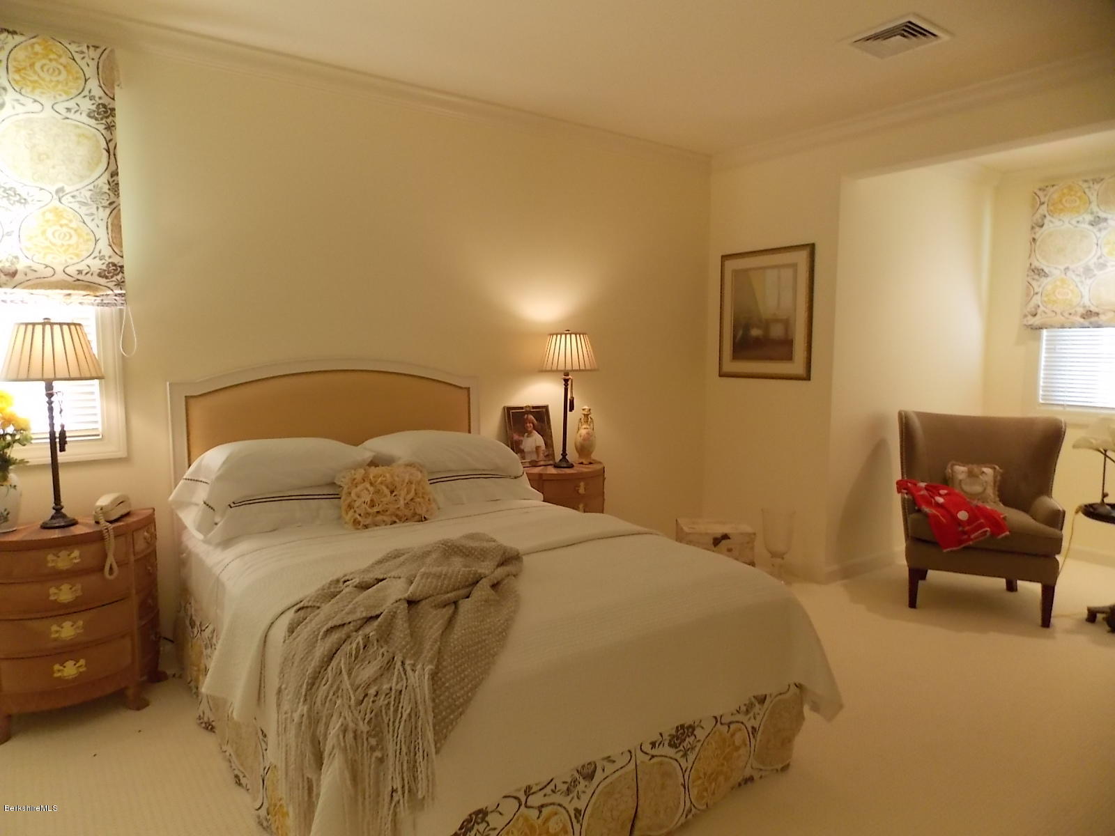 18 High Crest Road, Unit 18 Lenox, MA 01240 - Photo 22 of 34 a bedroom with a bed and lamp